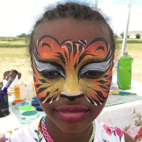 Face Painting Tiger A child in an orange tiger face-paint